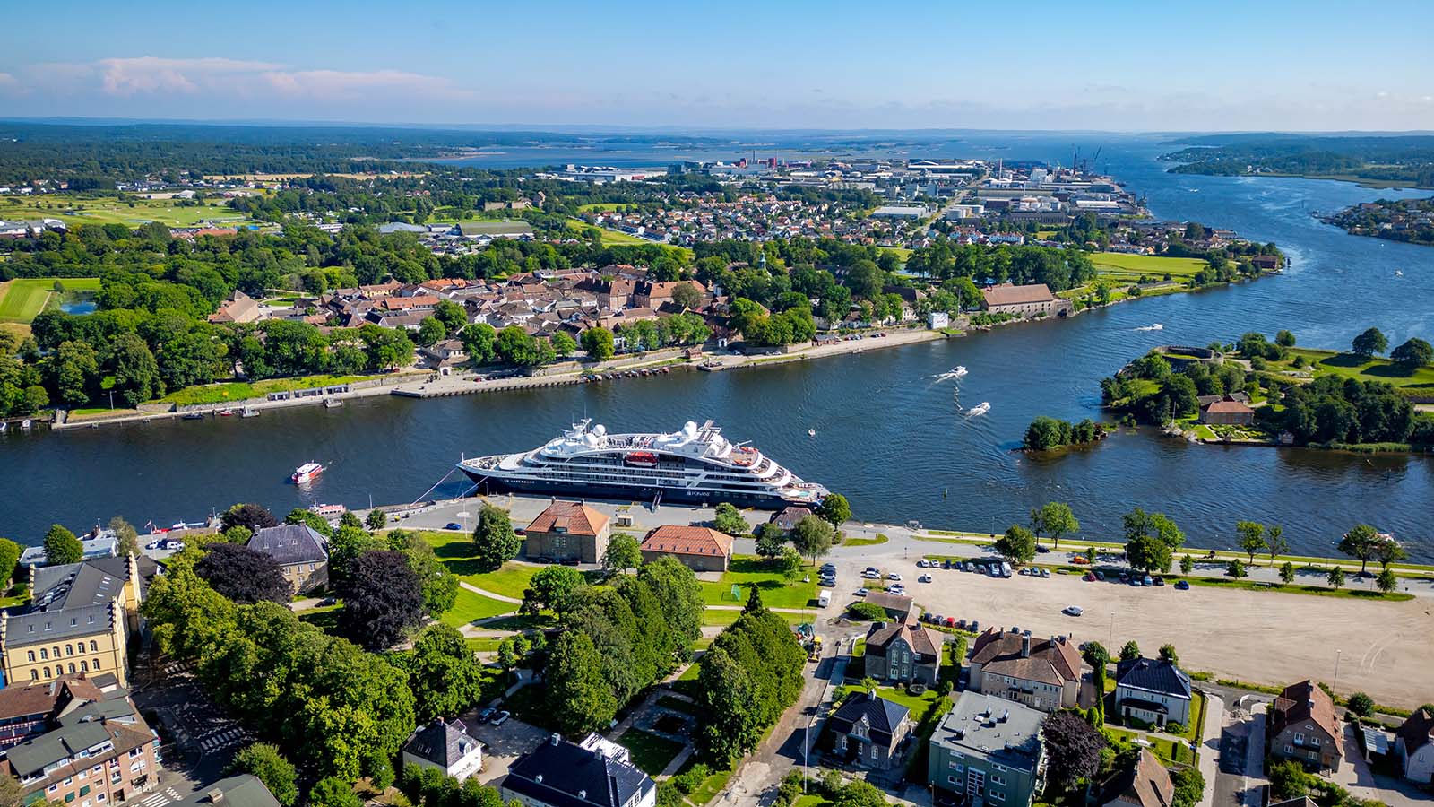 Aerial view of a cruise ship docked at Tollboden Quay in Fredrikstad, with the Old Town in the background